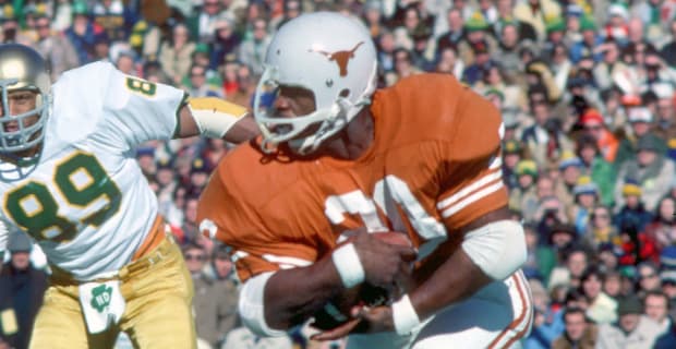 Texas Longhorns running back Earl Campbell on a rushing attempt during a college football game.